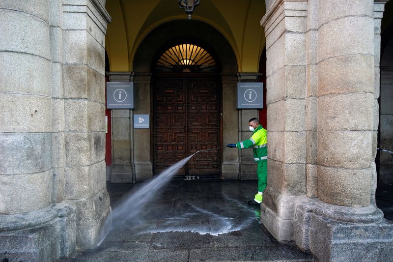 &copy; Reuters. Un operatore in azione a pulire e disinfettare le strade di Plaza Mayor durante il lockdown imposto a Madrid a fronte dell&apos;emergenza coronavirus, 5 aprile 2020