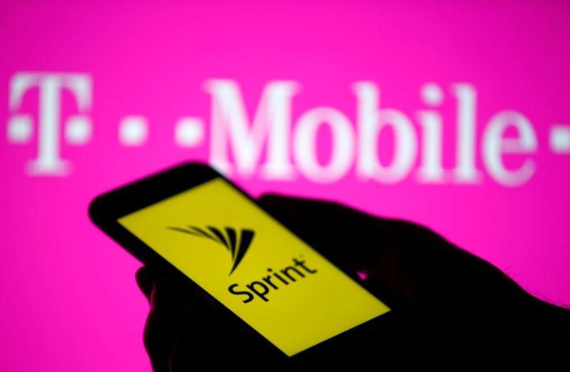 &copy; Reuters. A smartphone with Sprint logo are seen in front of a screen projection of T-mobile logo, in this picture illustration