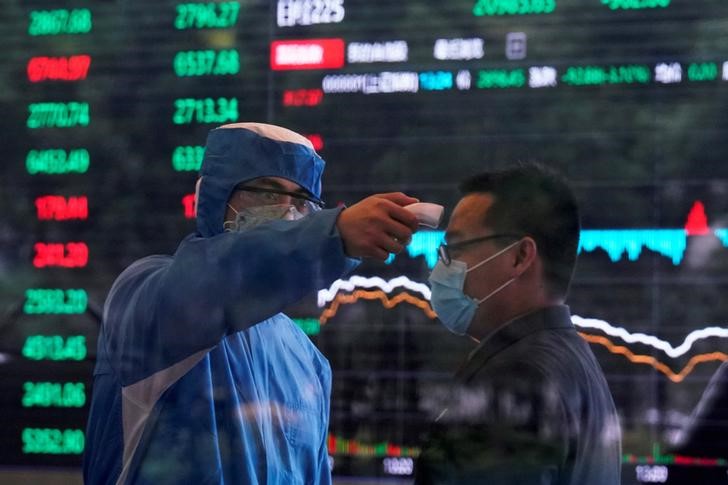 &copy; Reuters. A worker wearing a protective suit takes body temperature measurement of a man inside the Shanghai Stock Exchange building, as the country is hit by a new coronavirus outbreak, at the Pudong financial district in Shanghai