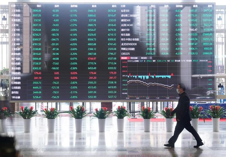 &copy; Reuters. Man wearing a face mask is seen inside the Shanghai Stock Exchange building, as the country is hit by a novel coronavirus outbreak, at the Pudong financial district in Shanghai