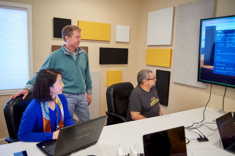 &copy; Reuters. CEO Mike Armistead and two Respond Software team members look at product designs in Mountain View