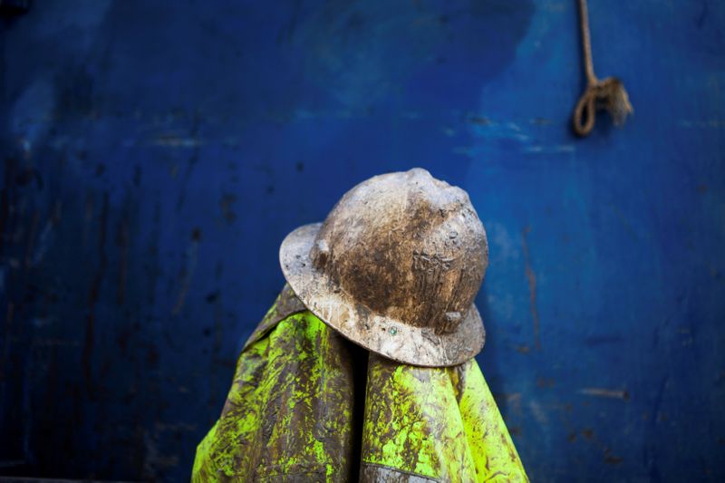 © Reuters. FILE PHOTO: Driller Justin Arney's hard hat and jacket rest on a truck during a lunch break, as they work to deepen the Brady family well in Woodland, California