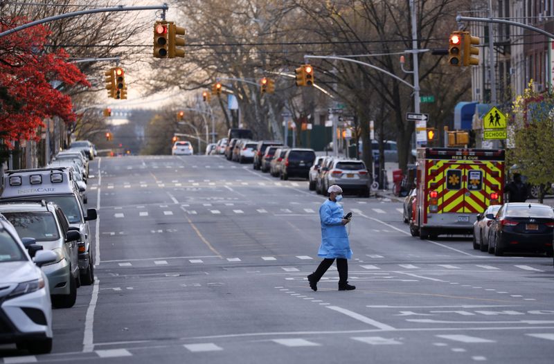 &copy; Reuters. Profissional de saúde atravessa rua vazia no Brooklyn
