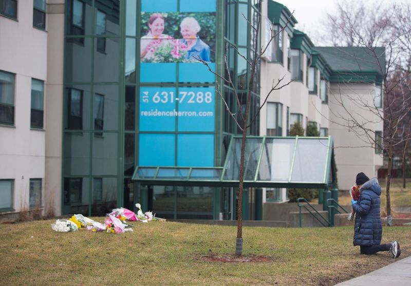 &copy; Reuters. Mulher reza em frente a abrigo de idosos em Montreal após uma série de mortos por coronavírus
