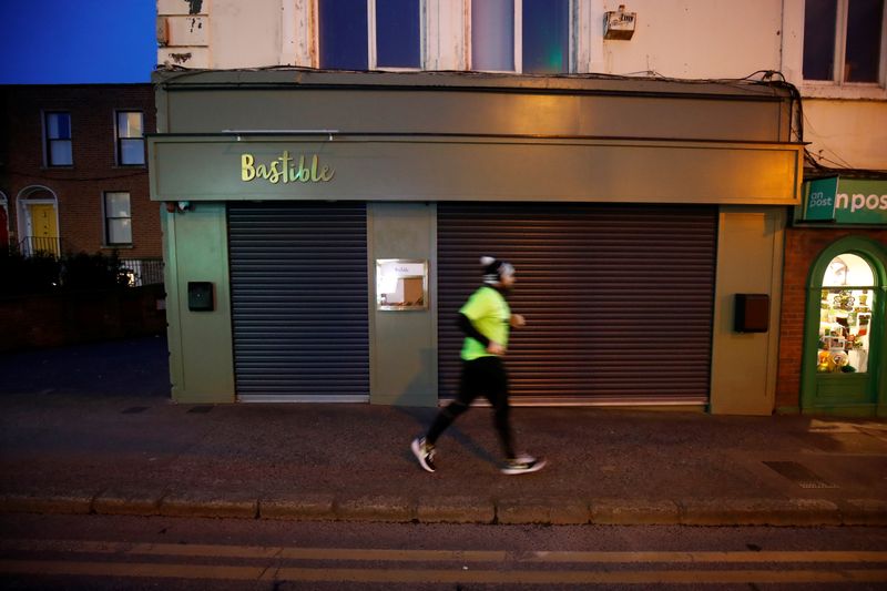 &copy; Reuters. A runner jogs past the shuttered Bastible restaurant, after it closed its doors on Sunday amid the growing threat from the coronavirus disease (COVID-19), in Dublin, Ireland