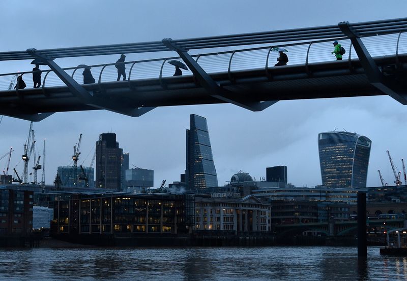 &copy; Reuters. City workers cross the Millennium footbridge in the financial district of London