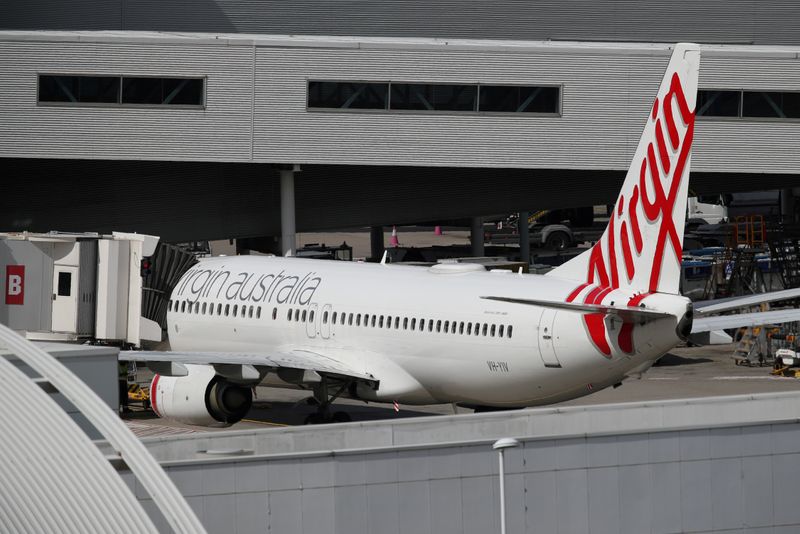 © Reuters. FILE PHOTO: A Virgin Australia plane at Kingsford Smith International Airport after Australia implemented an entry ban on non-citizens and non-residents due to the coronavirus outbreak