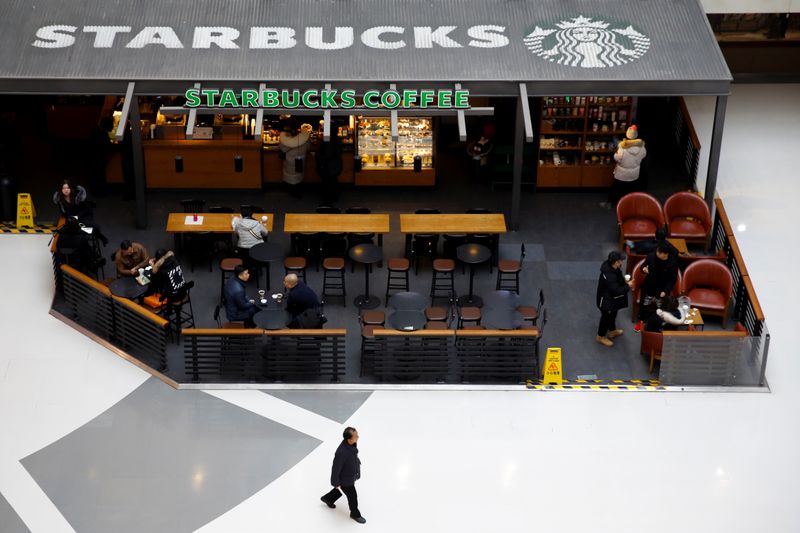 &copy; Reuters. FILE PHOTO:  People sit in a Starbucks cafe in a mall in Beijing