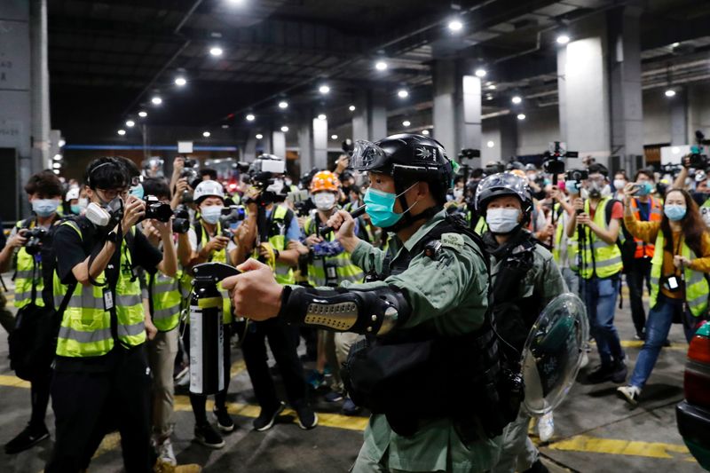&copy; Reuters. FILE PHOTO: File photo of a riot police officer holding a pepper spray as he tries to disperse anti-government protesters after a vigil to mourn student’s death, in Hong Kong