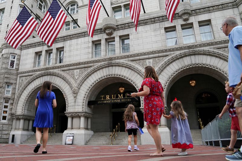 &copy; Reuters. A group of people approach the front facade of the Trump International Hotel to pose for photos in Washington