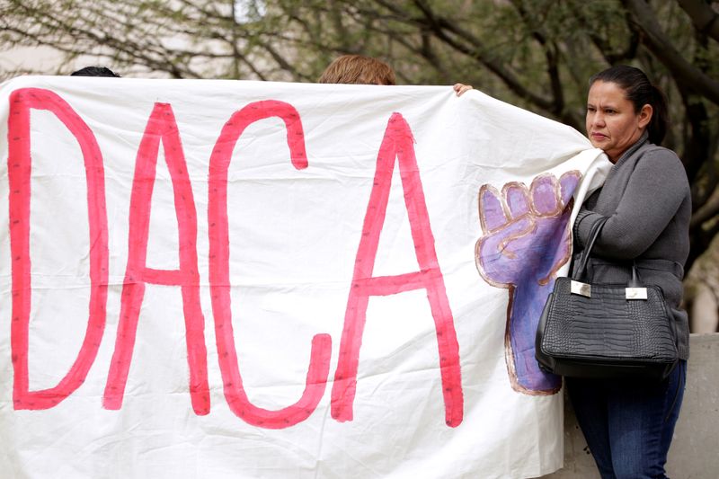 &copy; Reuters. FILE PHOTO:  Members of the Border Network for Human Rights and Borders Dreamers and Youth Alliance hold a banner during protest to demand that Congress pass a Clean Dream Act in El Paso