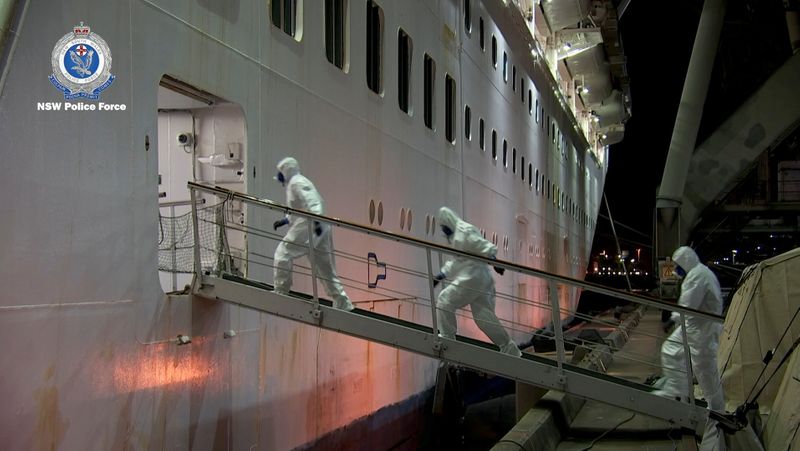 © Reuters. FILE PHOTO:  NSW Police personnel in personal protective equipment board the Ruby Princess during the Strike Force Bast raid of the cruise ship at Port Kembla