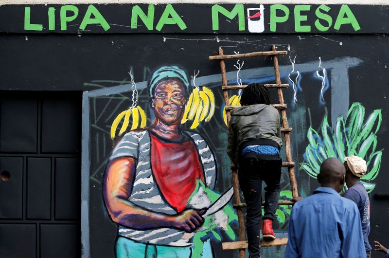 &copy; Reuters. FILE PHOTO: An artist works on a mural advocating for retail M-Pesa mobile phone cashless payments as a measure against the spread of the coronavirus disease (COVID-19) in Nairobi