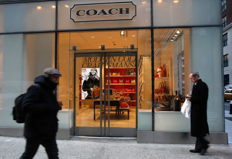 &copy; Reuters. FILE PHOTO: People walk past a Coach store on Madison Avenue in New York