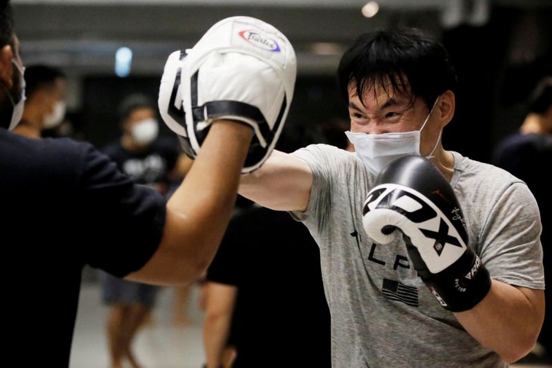 &copy; Reuters. A student of a martial arts center trains while wearing a surgical mask to protect himself from coronavirus disease (COVID-19) in Taipei