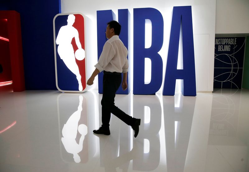 &copy; Reuters. FILE PHOTO: A man walks past an NBA logo at an NBA exhibition in Beijing