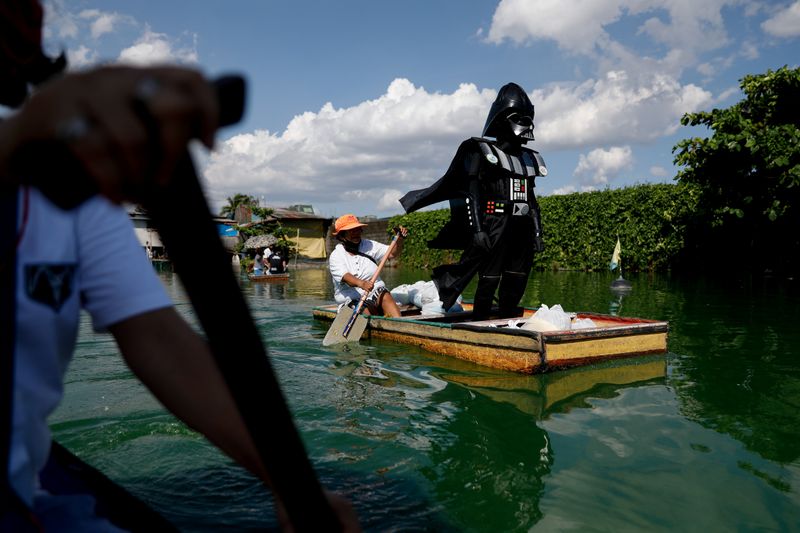 © Reuters. Village officer dressed as Darth Vader delivers relief goods amid coronavirus lockdown