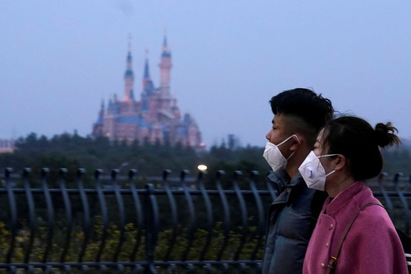 &copy; Reuters. Visitantes usam máscara em parque da Disney em Xangai, na China