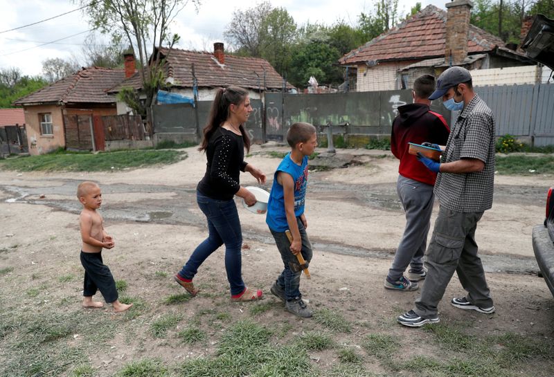 © Reuters. A Roma family stands to get food donation at a slum during the coronavirus disease (COVID-19) outbreak in Miskolc