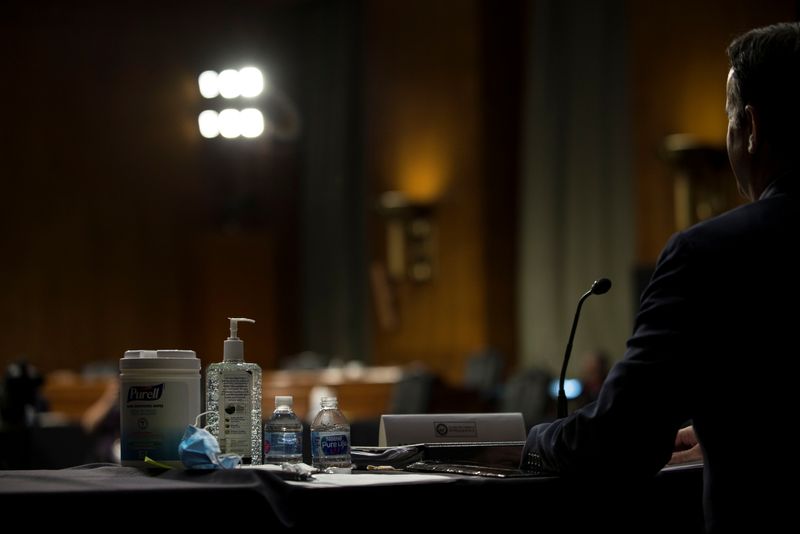 &copy; Reuters. Sanitizers are placed on the table for nominee U.S. Rep. John Ratcliffe, R-TX, as he testifies before a Senate Intelligence Committee nomination hearing on Capitol Hill in Washington