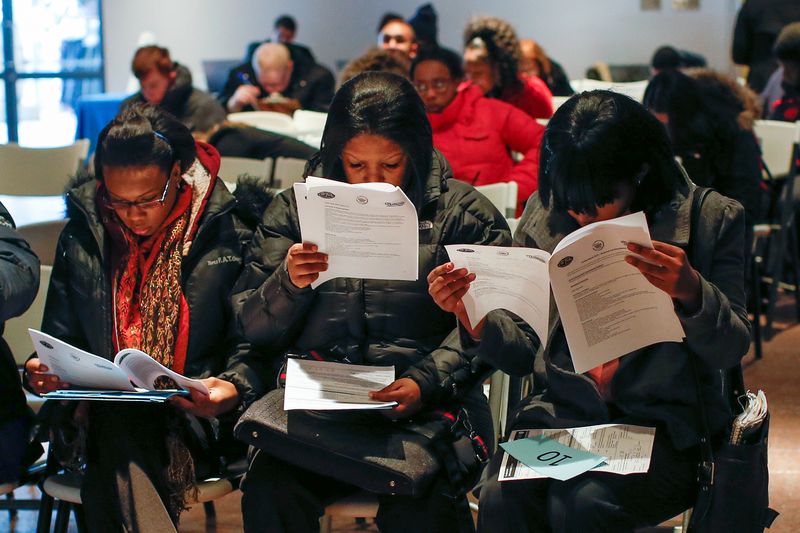 &copy; Reuters. People fill out application forms before a screening session for seasonal jobs at Coney Island in the Brooklyn borough of New York