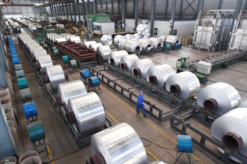 &copy; Reuters. FILE PHOTO: Workers are seen next to aluminium rolls at a plant in Binzhou