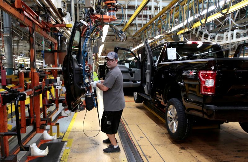 © Reuters. FILE PHOTO: A Ford Motor assembly worker works on a 2018 Ford F150 pick-up truck at Ford's Dearborn Truck Plant during the 100-year celebration of the Ford River Rouge Complex in Dearborn