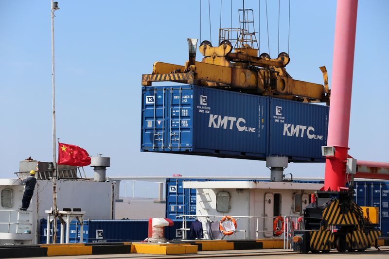 &copy; Reuters. Crane lifts containers to be loaded onto a cargo vessel at a port in Qidong city of Nantong