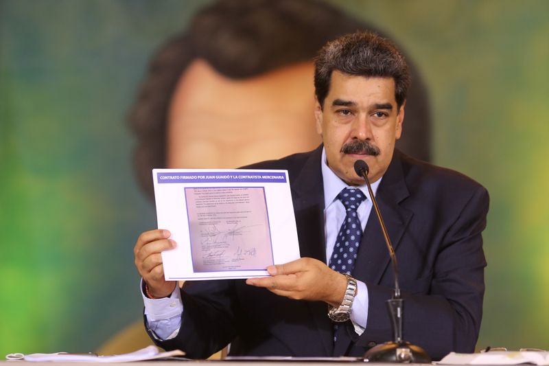 © Reuters. Venezuela's President Nicolas Maduro holds a document during a virtual news conference in Caracas