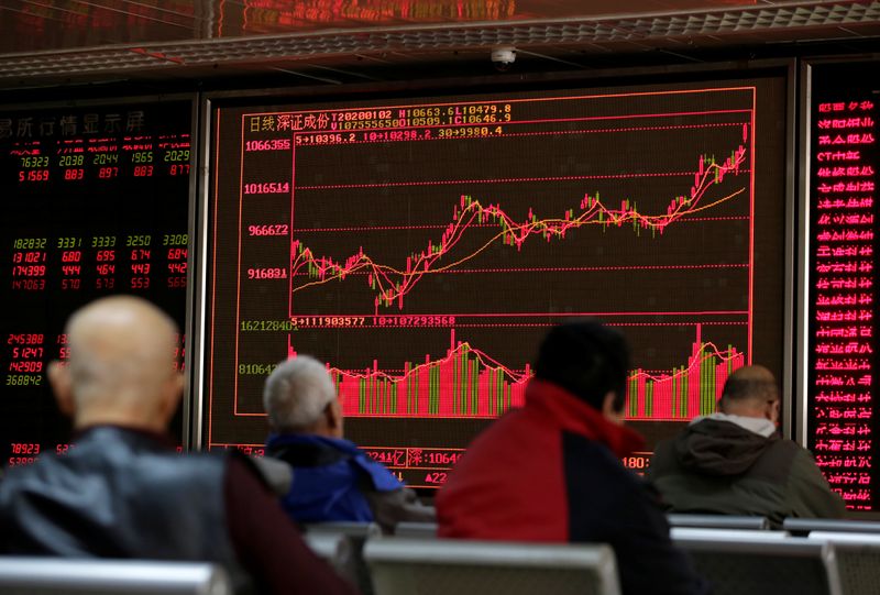 © Reuters. A board shows stock information at a brokerage office in Beijing