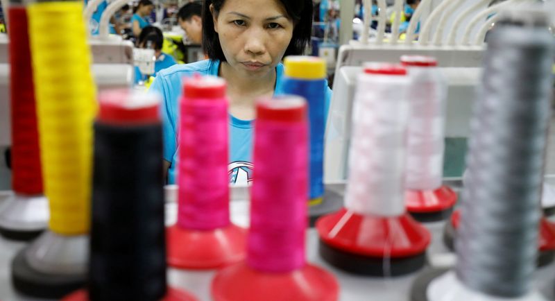 &copy; Reuters. FILE PHOTO: A woman works at Maxport garment company in Hanoi