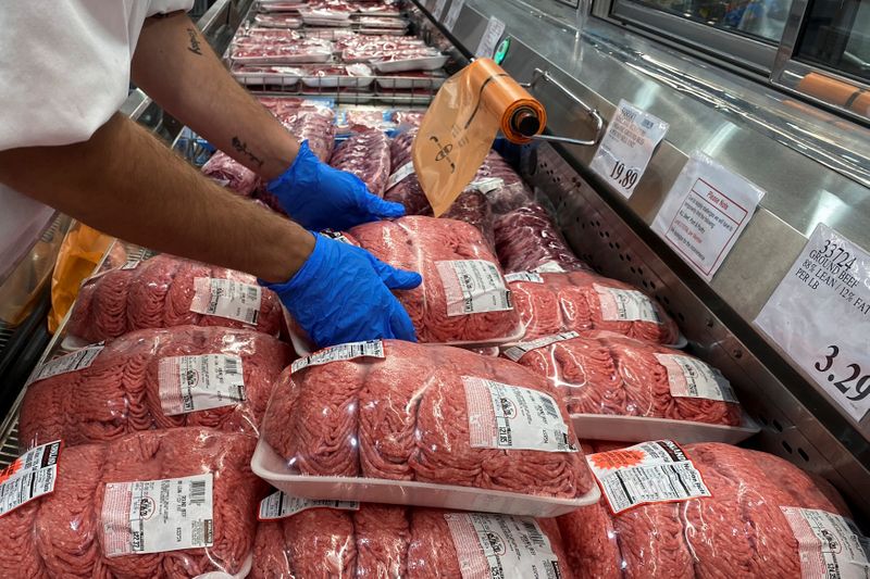 &copy; Reuters. FILE PHOTO:  Worker stacks beef in meat section of Costco during coronavirus pandemic in Webster, Texas