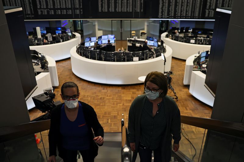 &copy; Reuters. Due donne con indosso la mascherina alla sede della Borsa di Francoforte, mentre i mercati regiscono all&apos;epidemia di coronavirus