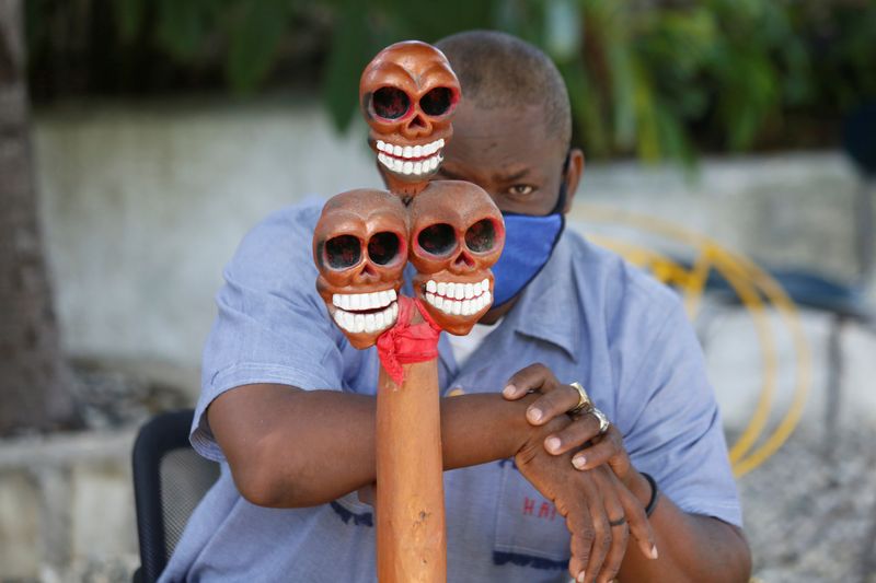 &copy; Reuters. A voodoo priest wearing a face mask to protect from the spread of the coronavirus disease (COVID-19) takes part in a ceremony in Port-au-Prince