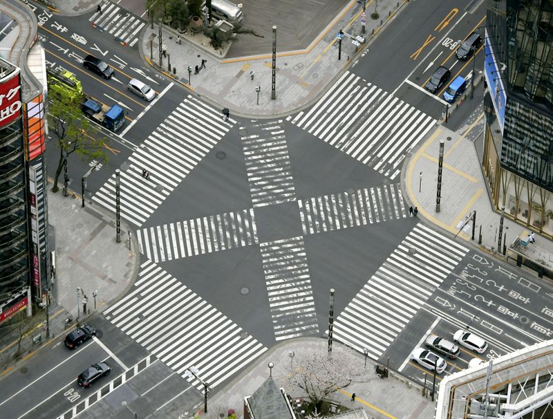 &copy; Reuters. An aerial view shows less than usual passersby seen at a pedestrian crossing at Ginza district in Tokyo