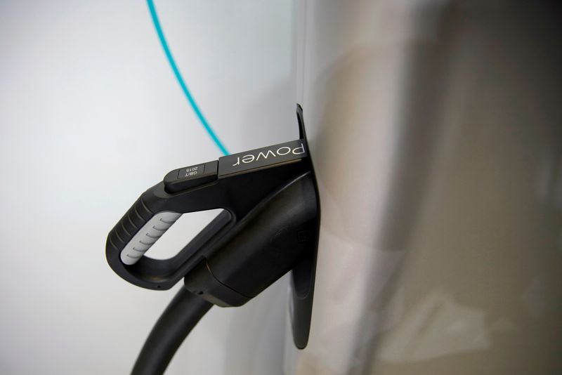 © Reuters. FILE PHOTO: Charging plug attached to an electric vehicle (EV)