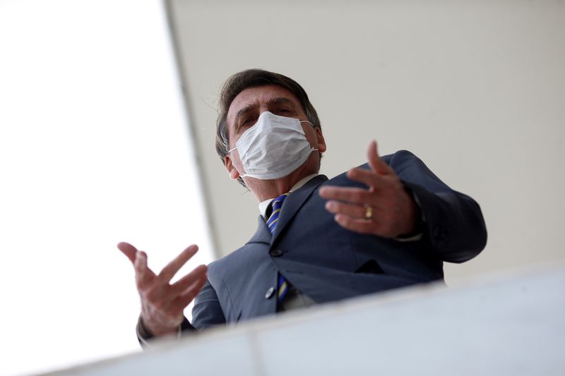 &copy; Reuters. Brazil&apos;s President Jair Bolsonaro wearing a protective mask gestures as he speaks with journalists, amid the coronavirus disease (COVID-19) outbreak, at the Planalto Palace, in Brasilia