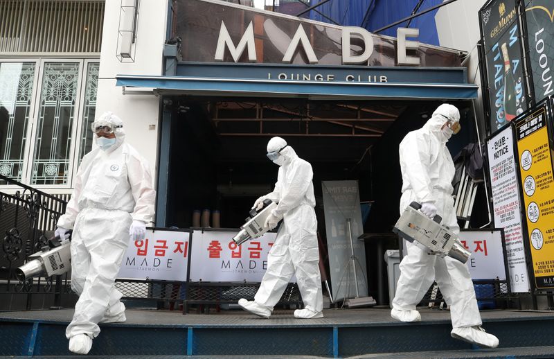 &copy; Reuters. Quarantine worker spray disinfectants in front of a night club on the night spots in the Itaewon neighborhood, following the coronavirus disease (COVID-19) outbreak, in Seoul