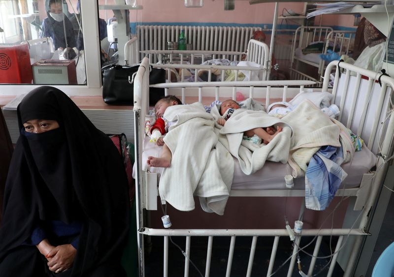 &copy; Reuters. Newborn children who lost their mothers during the yesterday&apos;s attack lie on a bed at a hospital, in Kabul