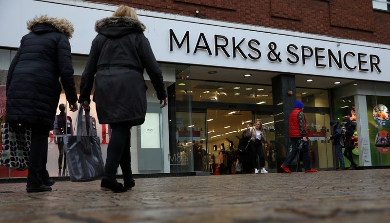 © Reuters. FILE PHOTO: Shoppers walk past a branch of Marks and Spencer in Altrincham, Britain