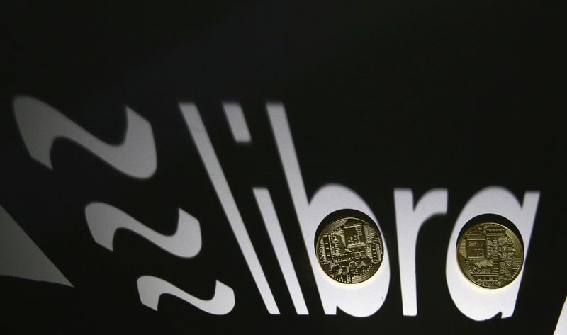 &copy; Reuters. Shadow of a 3D-printed Facebook Libra cryptocurrency logo is seen near cryptocurrency representation in this illustration taken