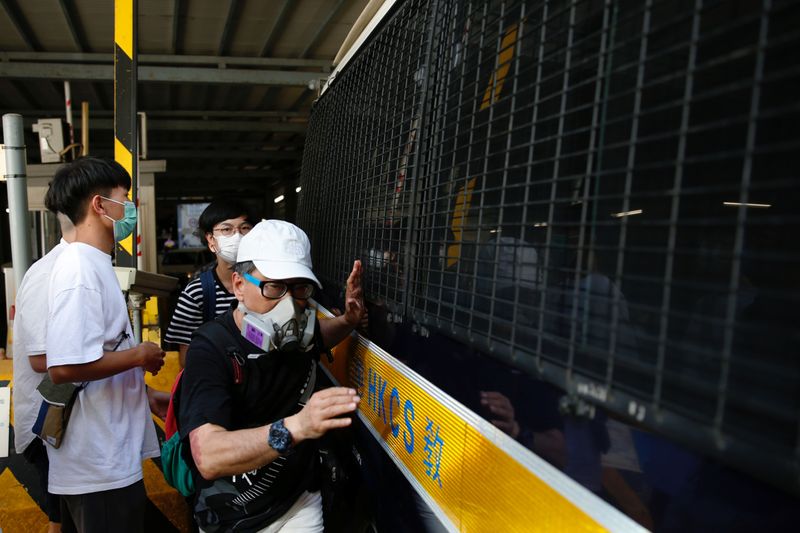 &copy; Reuters. Supporters bid farewell to a prison van after an anti-government protester Sin Ka-ho has been sentenced four years for rioting, in Hong Kong