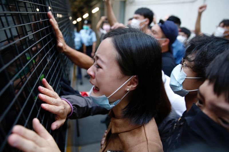 © Reuters. A family member cries and bid farewell to a prison van after an anti-government protester Sin Ka-ho has been sentenced four years for rioting, in Hong Kong