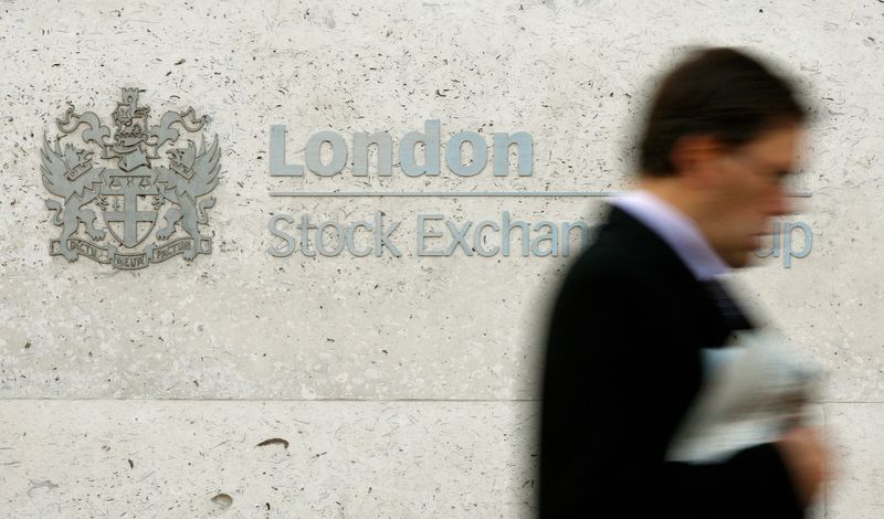 &copy; Reuters. A man walks past the London Stock Exchange in the City of London