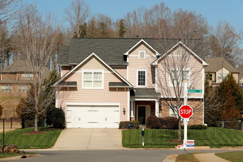 &copy; Reuters. A home stands behind a real estate sign in a new development in York County, South Carolina