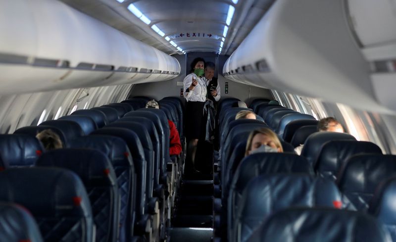 &copy; Reuters. FILE PHOTO: Flight attendants talk in a nearly empty cabin on a Delta Airlines flight operated by SkyWest Airlines