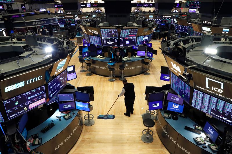 &copy; Reuters. A man cleans up on the trading floor, following traders positive for Coronavirus disease (COVID-19), at the NYSE in New York