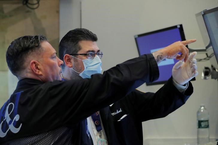 &copy; Reuters. Traders work on the floor of the New York Stock Exchange (NYSE) as the building prepares to close indefinitely due to the coronavirus disease (COVID-19) outbreak in New York