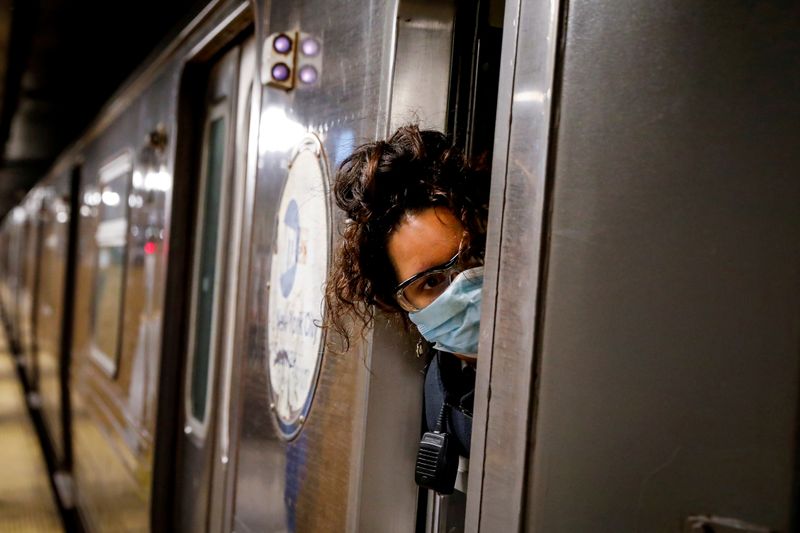 &copy; Reuters. FILE PHOTO: A conductor looks out of an MTA subway car at a stop, during the outbreak of the coronavirus disease (COVID-19) in Brooklyn, New York