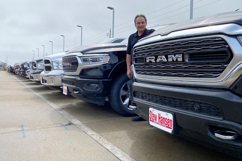 &copy; Reuters. Jerry Bill, general manager of Stew Hansen Chrysler Dodge Jeep Ram, poses among a line of Ram trucks in Urbandale